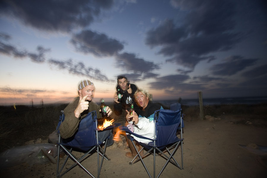 Beach campfire at dusk with friends
