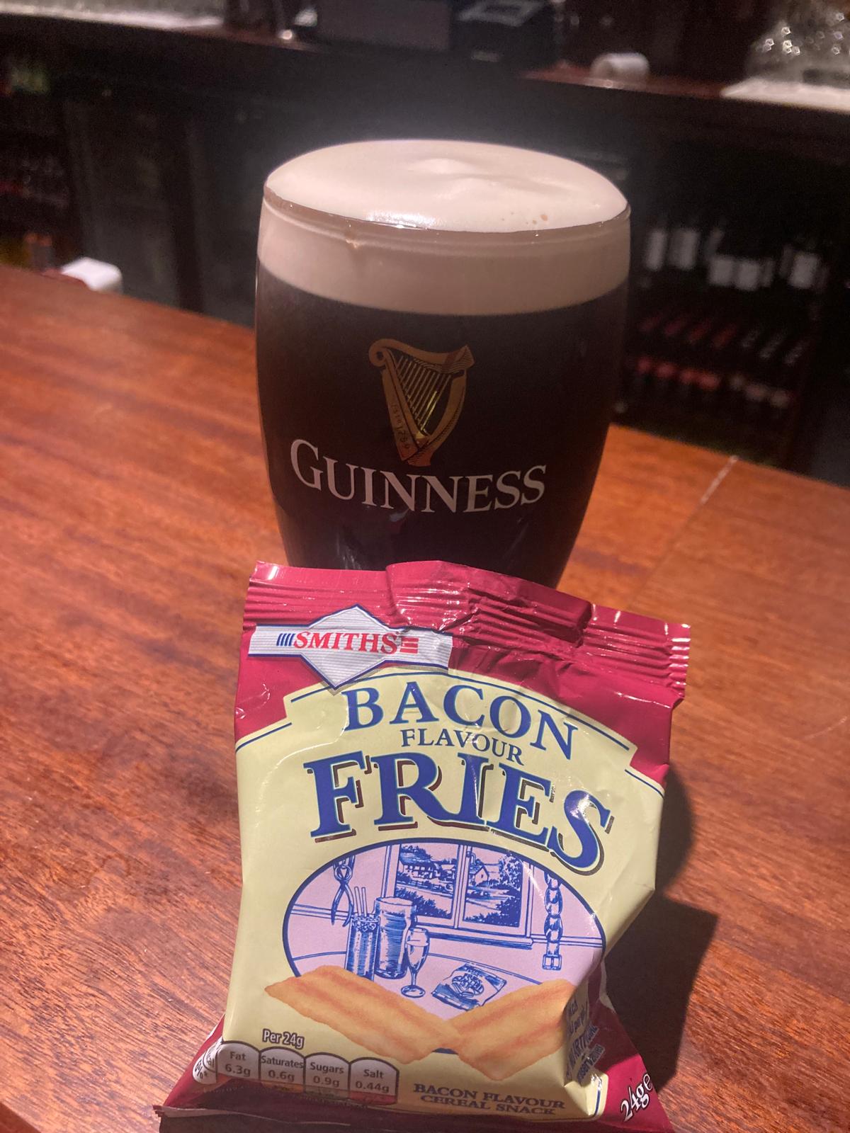 A pint of Guinness and bacon fries