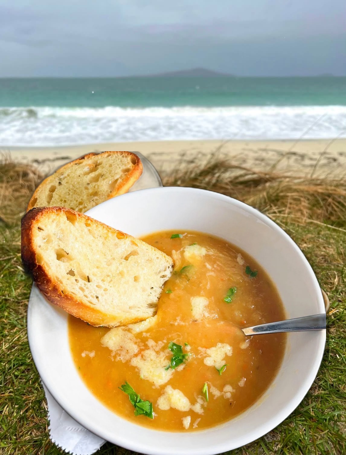 Bowl of homemade soup and fresh bread on the beach at Magheroarty